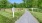 a path with signs on it and trees on the side