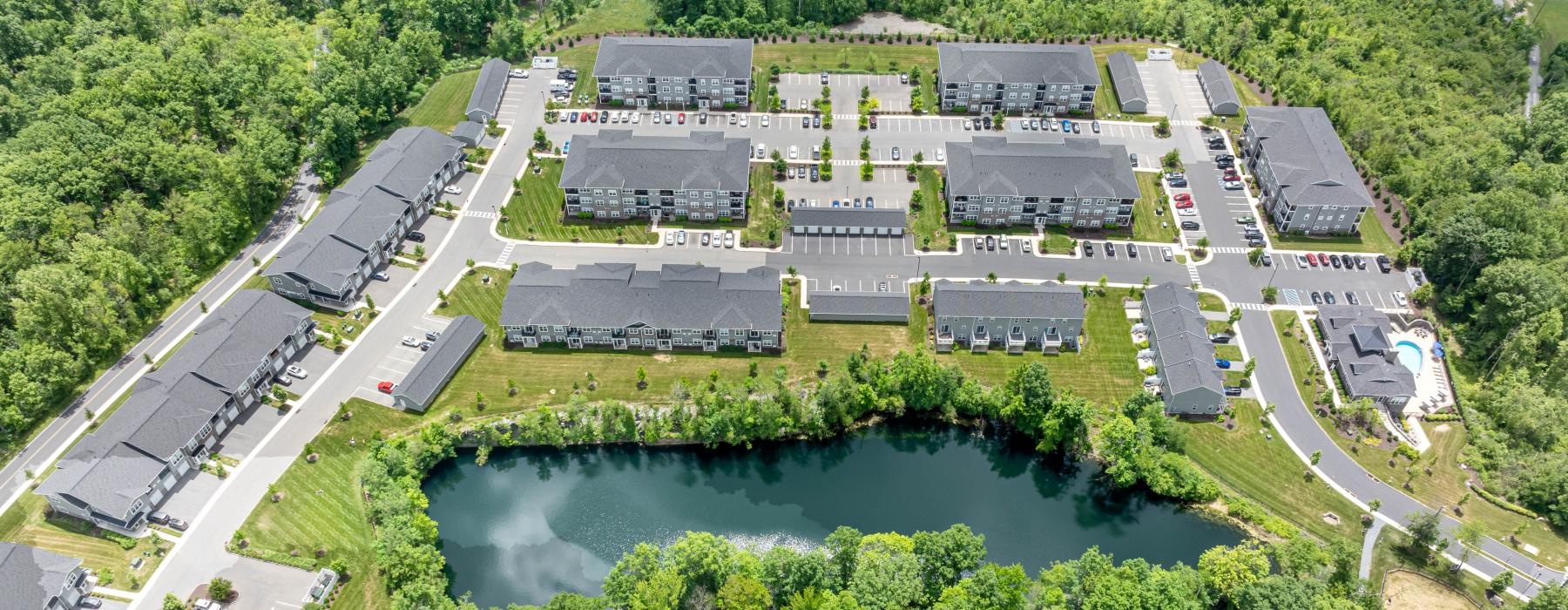 a large building with a pond in front of it