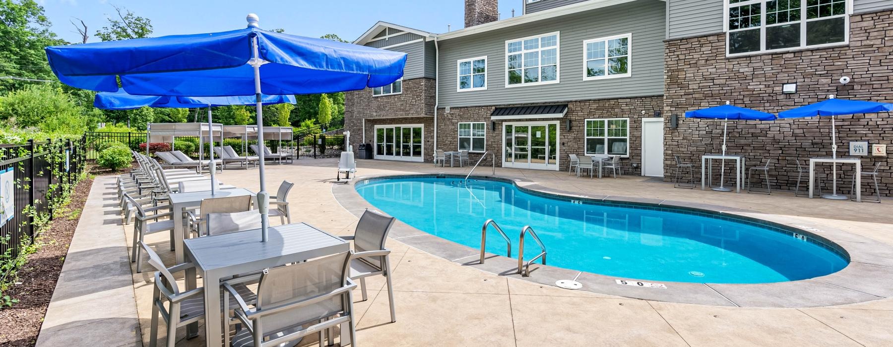 a swimming pool and chairs next to the property