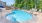 a swimming pool with trees in the background