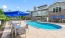 a swimming pool and chairs next to the property